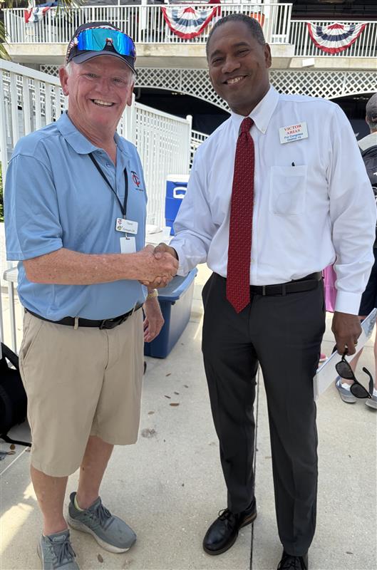 Victor Arias shaking hands with a supporter, demonstrating bipartisan engagement
