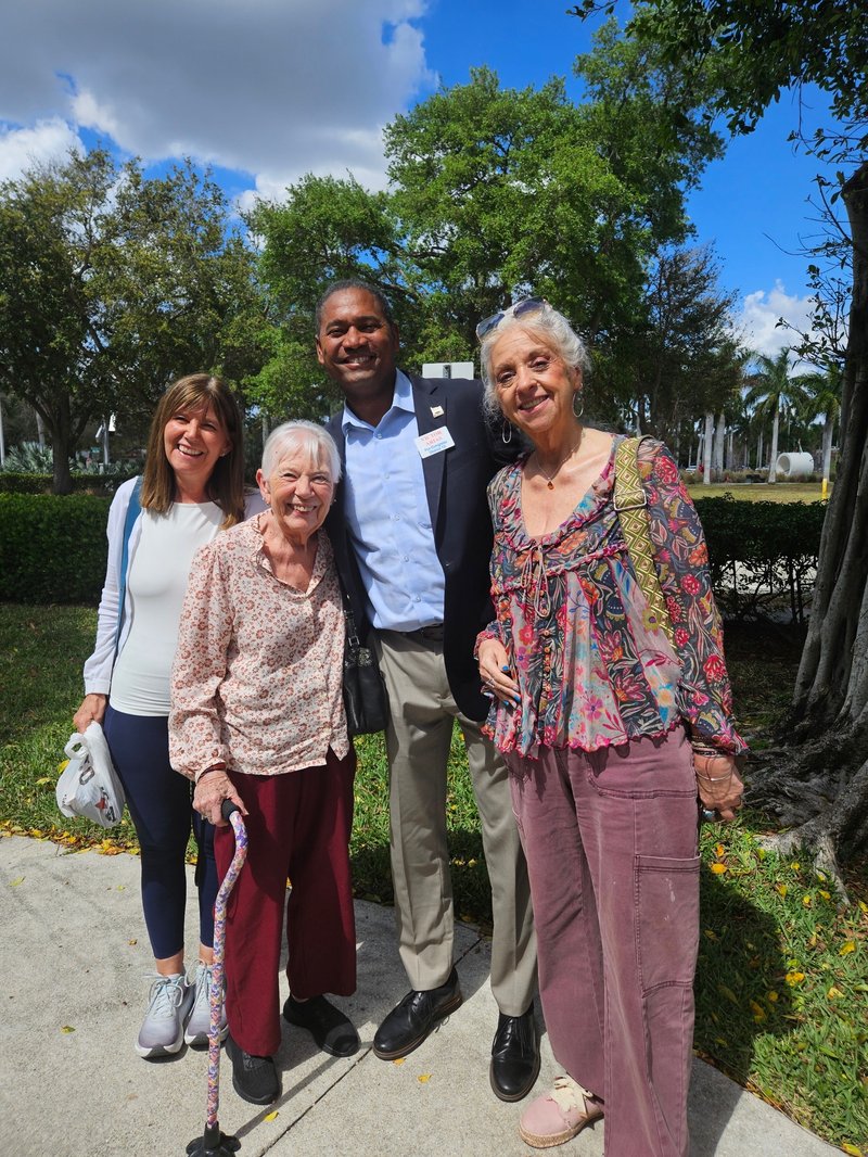 Victor Arias with three community members outdoors in Southwest Florida
